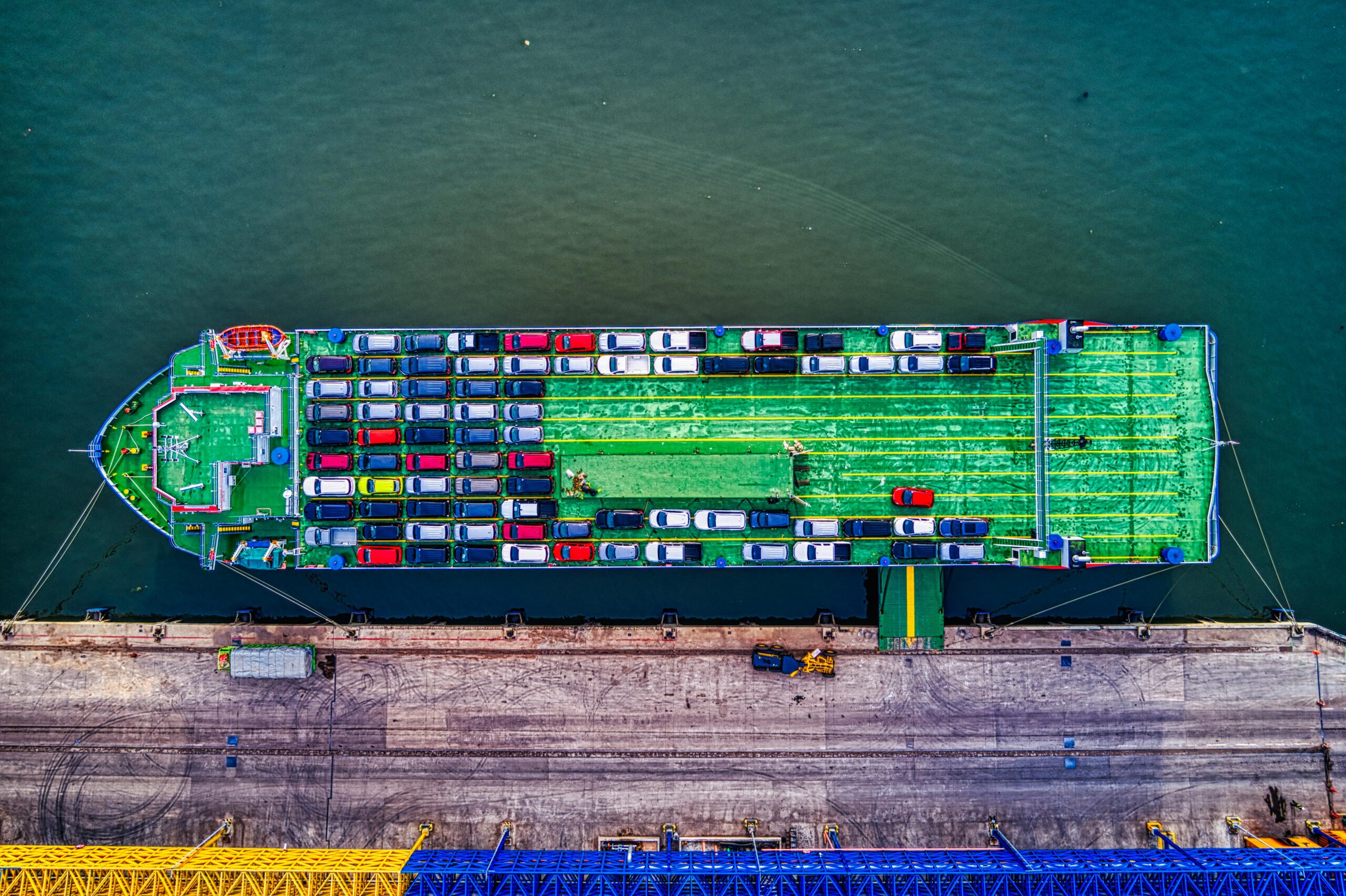 Aerial view of a car transport ship docked at Bekasi port, Indonesia.